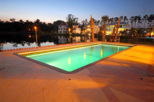 Claremont fiberglass inground swimming pool with curved design in a landscaped backyard by Calm Water Pools.
