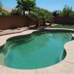 Laguna freeform inground fiberglass swimming pool with organic curved design in a residential backyard setting