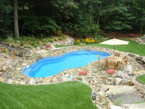 Laguna freeform inground fiberglass pool with built-in spa, curved steps, and surrounding stone deck in a landscaped backyardIf you’d like, I can also generate a few variations targeting different keywords like *backyard oasis*, *family swimming pool*, or a specific location (e.g., “in Florida”) to match your page’s SEO focus.
