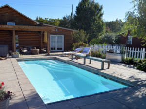 Empress classic inground fiberglass Latham pool with elegant curved shape and built-in entry steps by Calm Water Pools